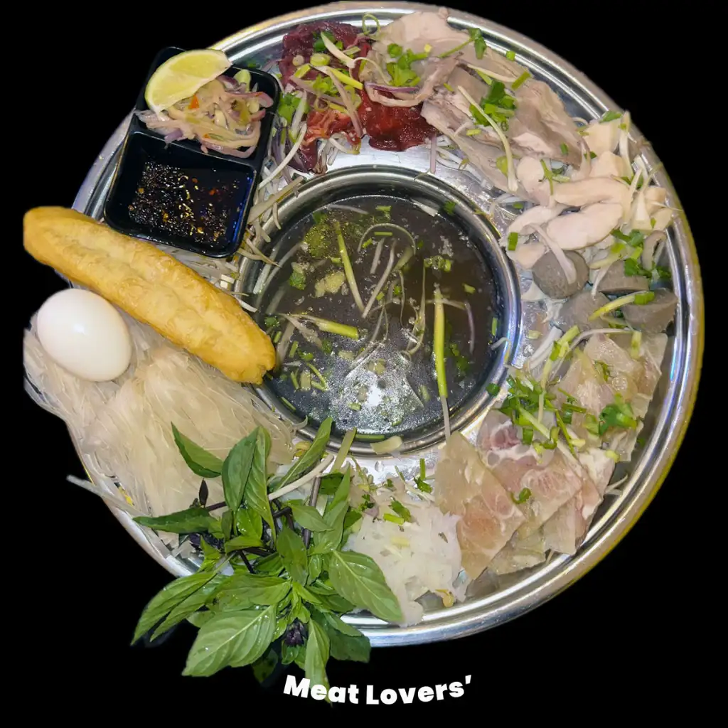 A plate of meats with pho in the middle
