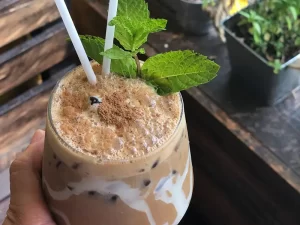 Cold Vietnamese coffee with straws and mint