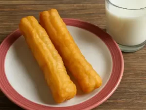Crispy bread sticks and a glass of milk
