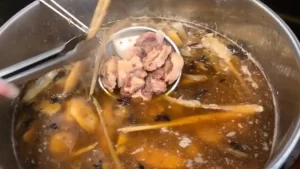 A pot of pho soup with oxtail meat